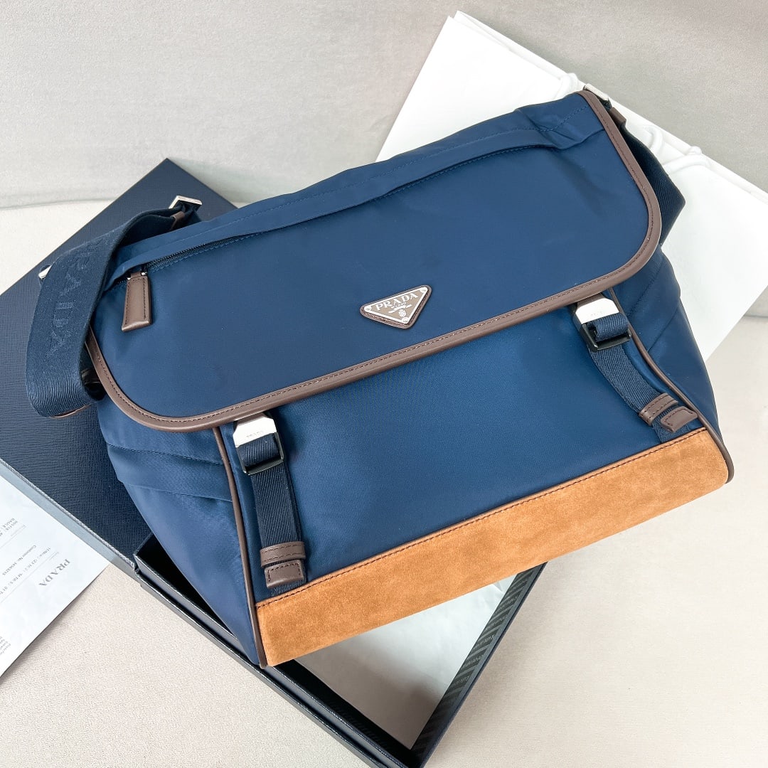 PRADA double buckle nylon messenger bag: This double buckle nylon messenger bag features a versatile two tone design. Made with imported parachute nylon fabric, it's waterproof and durable. The suede upper is luxurious and high quality, feat
