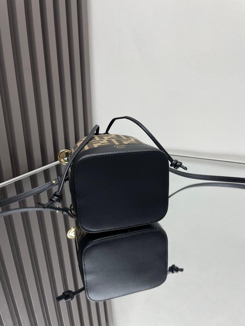 Fendi Mon Tresor: Mon Tresor small bucket bag in black with monogram canvas. Made of fabric, fully embroidered with an FF pattern jacquard and finished with clear sequins. Lined interior with silver tone hardware. Feat