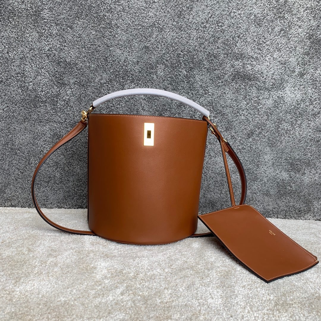 Celine Bucket: BUCKET 16 Calfskin Leather Handbag 9 x 10 x 9 inches (23 x 25 x 23 cm) Calfskin leather lining; fabric turn lock closure; removable zip pocket; removable leather shoulder strap 20 inches (52 cm) long;