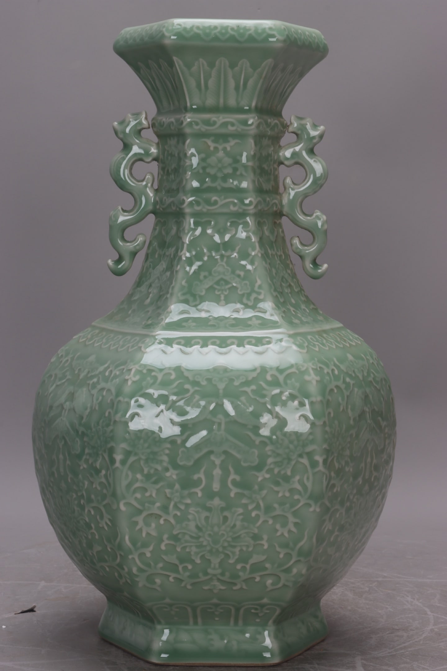 Qing Dynasty, Qianlong Period, celadon carved floral and fish double-eared vase: Qing Dynasty, Qianlong period celadon vase with carved floral and fish designs and two handles, 35 cm high, 12 cm in mouth diameter, 21 cm in belly diameter, and 13 cm in base diameter. Provenance:Pri