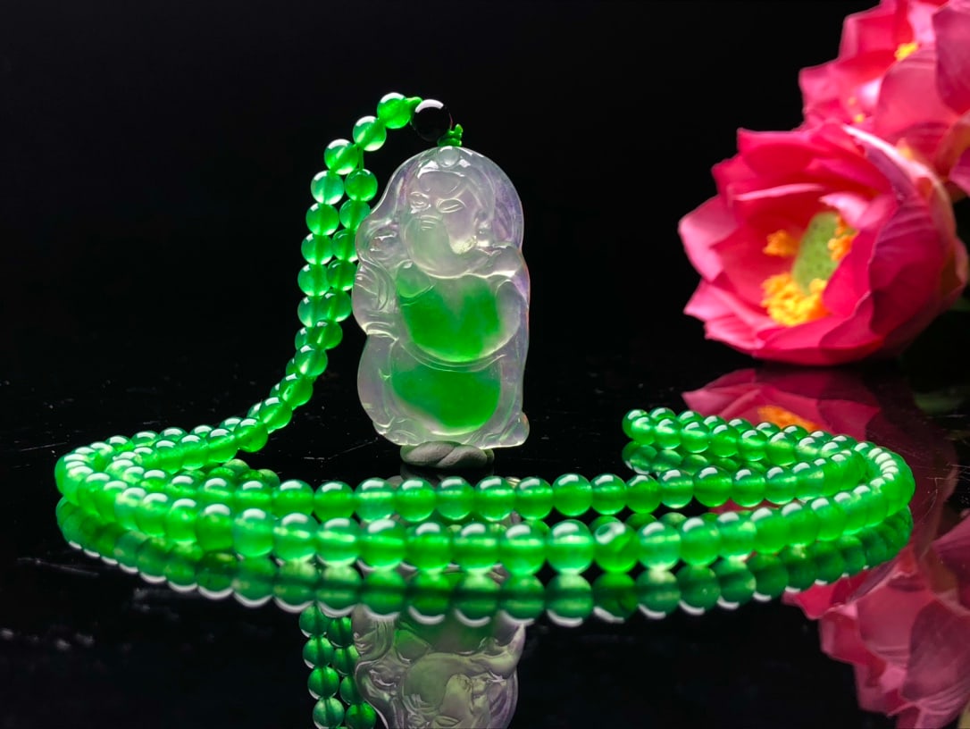 A high ice, high fluorescence jadeite necklace pendant with floating patterns and a God of Wealth (1 of 8)