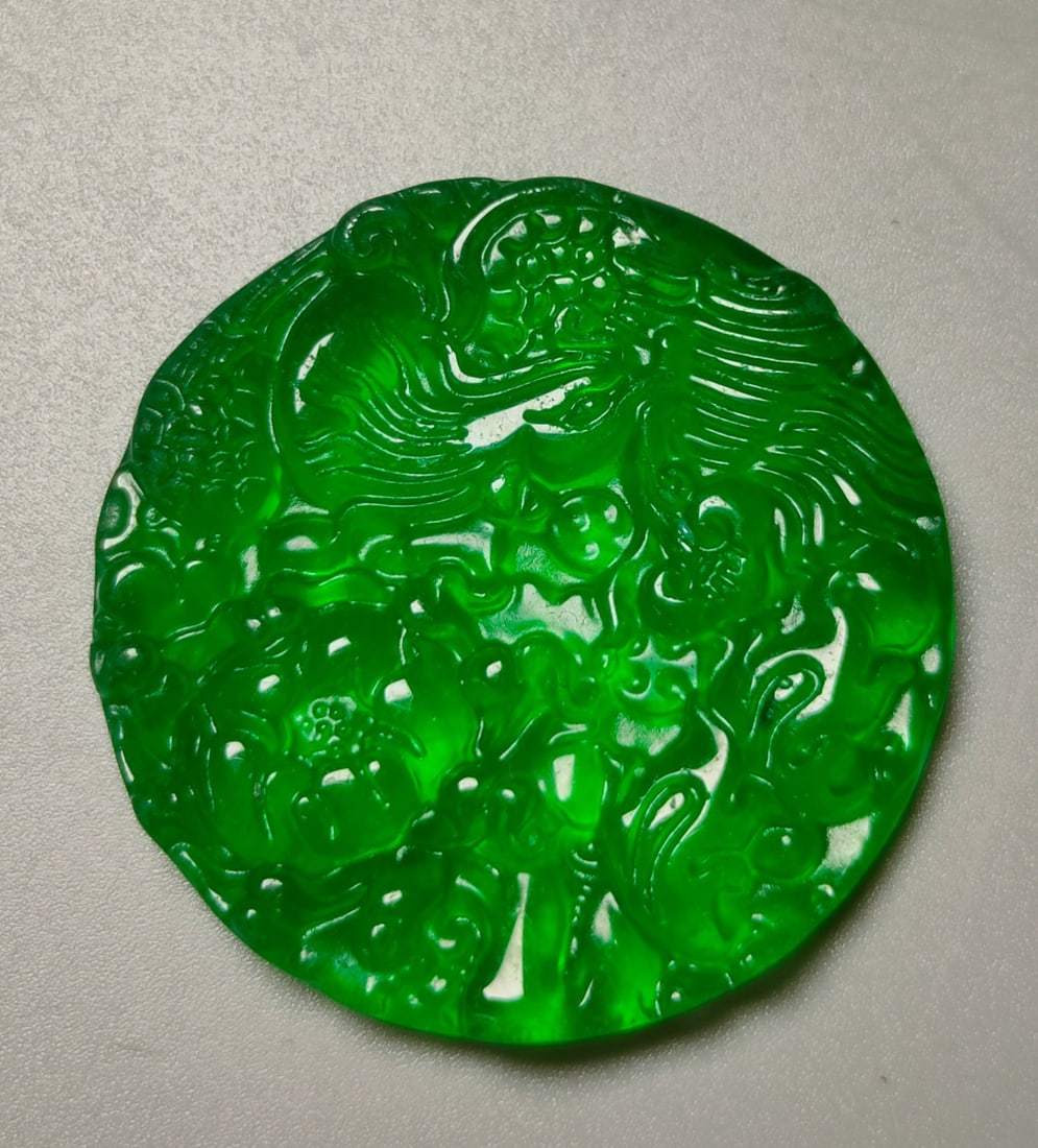 A top-grade imperial green jadeite pendant featuring a phoenix playing with a peony. (1 of 9)