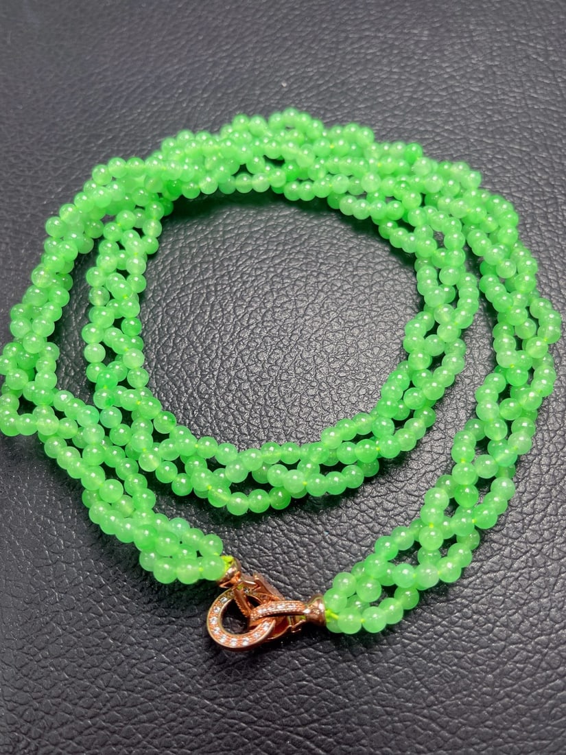 Jadeite Icy Light Green Three-Strand Braid Necklace: A light green, icy jadeite necklace with a three-strand braid design; the jadeite is translucent and lustrous, with each bead full and exquisite. Provenance:from a private collector in Ankara, Turkey.