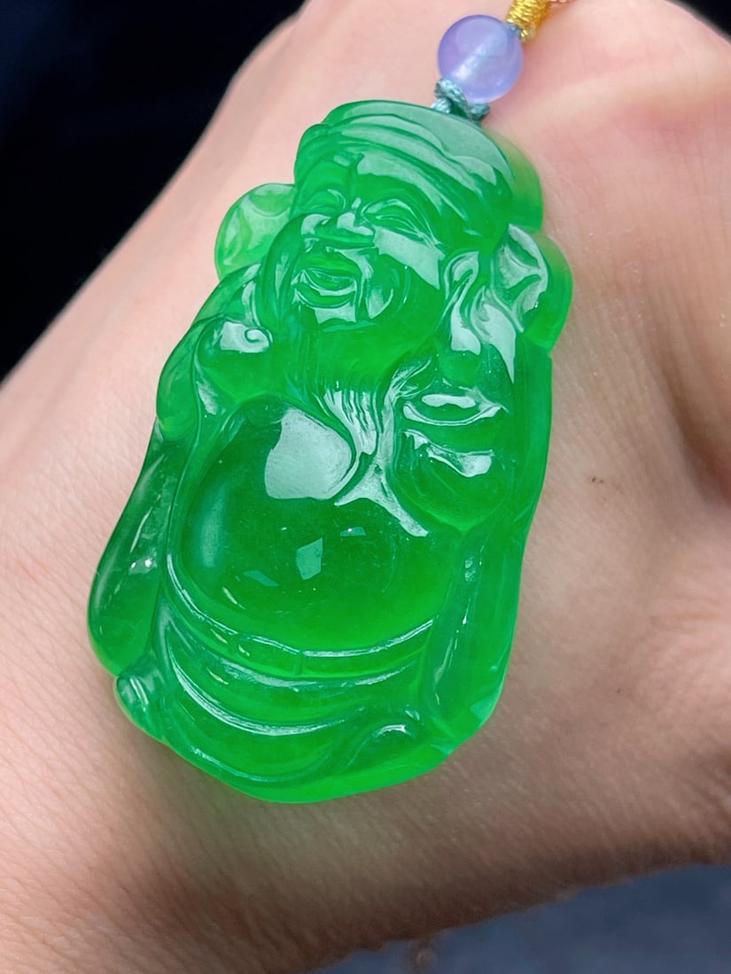 Jadeite icy green full-green wealth god: Jadeite of the icy type, full green color, resembling a wealth god, is translucent and lustrous, three-dimensional and full, with excellent texture and no cracks. Provenance:from a private collector i