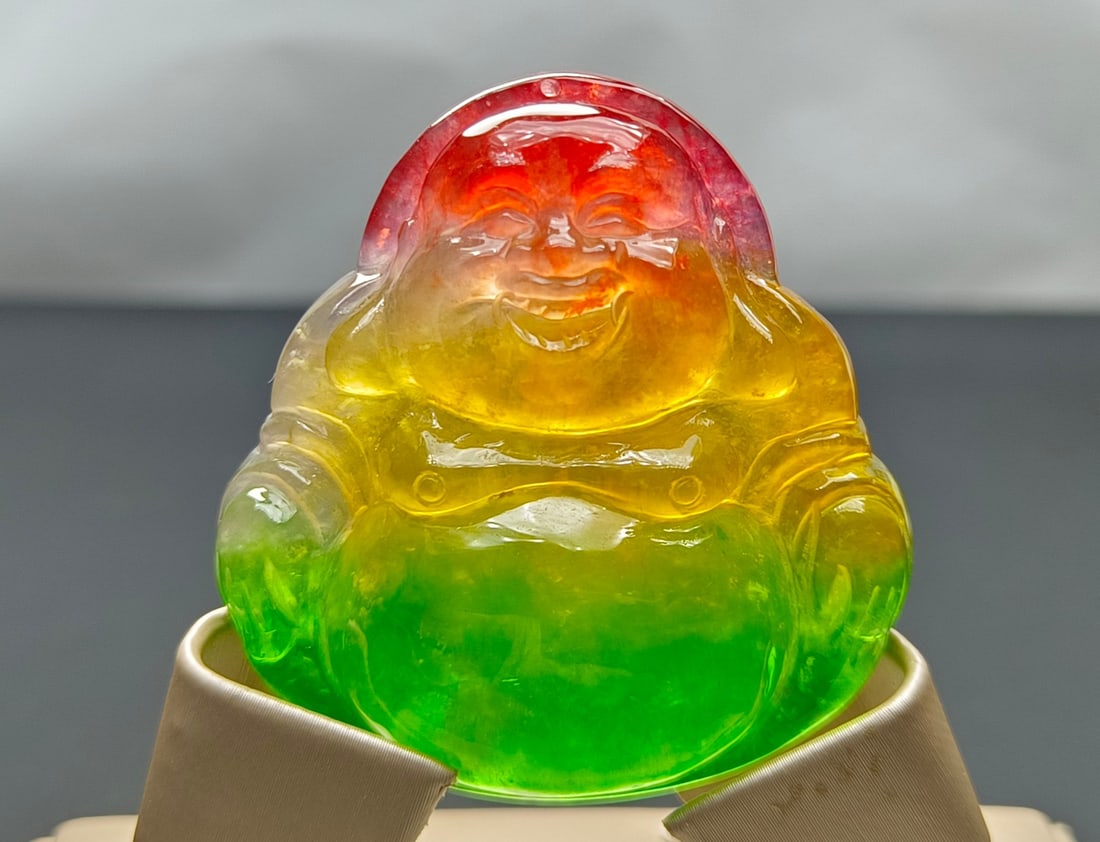 Top-grade dragon stone variety, colorful, extra-large and extra-thick jadeite Maitreya Buddha: Top-grade dragon stone jadeite Maitreya Buddha, multicolored, extra-large and extra-thick, with excellent translucency. Super perfect. Provenance:Private collection, Kiev, Ukraine. Our cooperative log