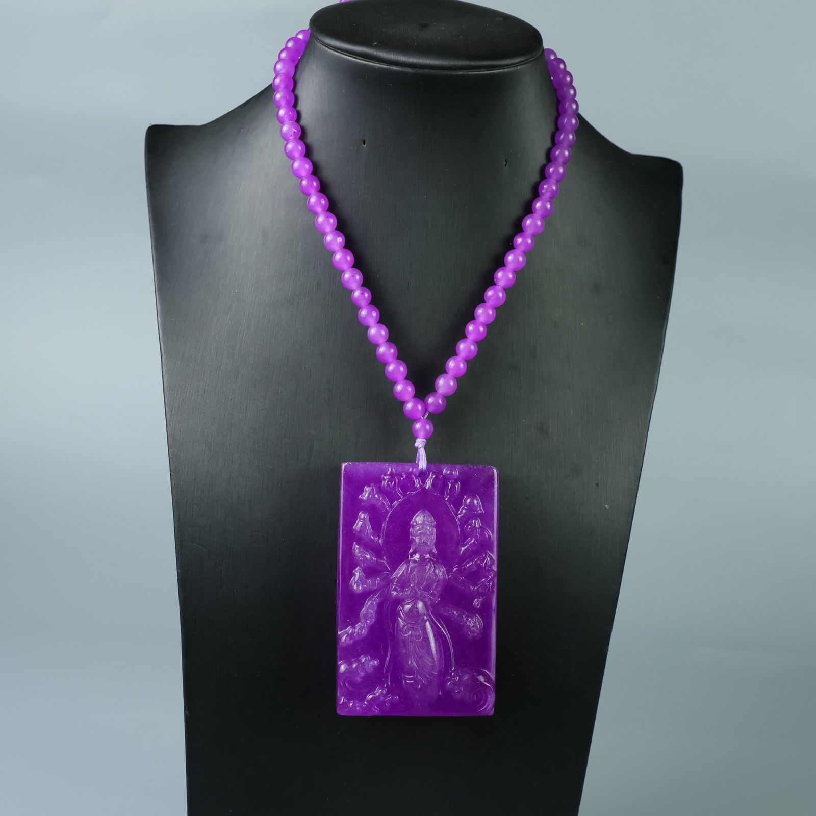 Perfectly crafted high-quality ice-crystal carving of the Thousand-Hand Guanyin plaque.: This exquisitely carved Thousand-Hand Guanyin pendant is made of high-grade icy jadeite. The base is pure, rich, clean, and translucent with a strong fluorescent effect and excellent rigidity. It is a