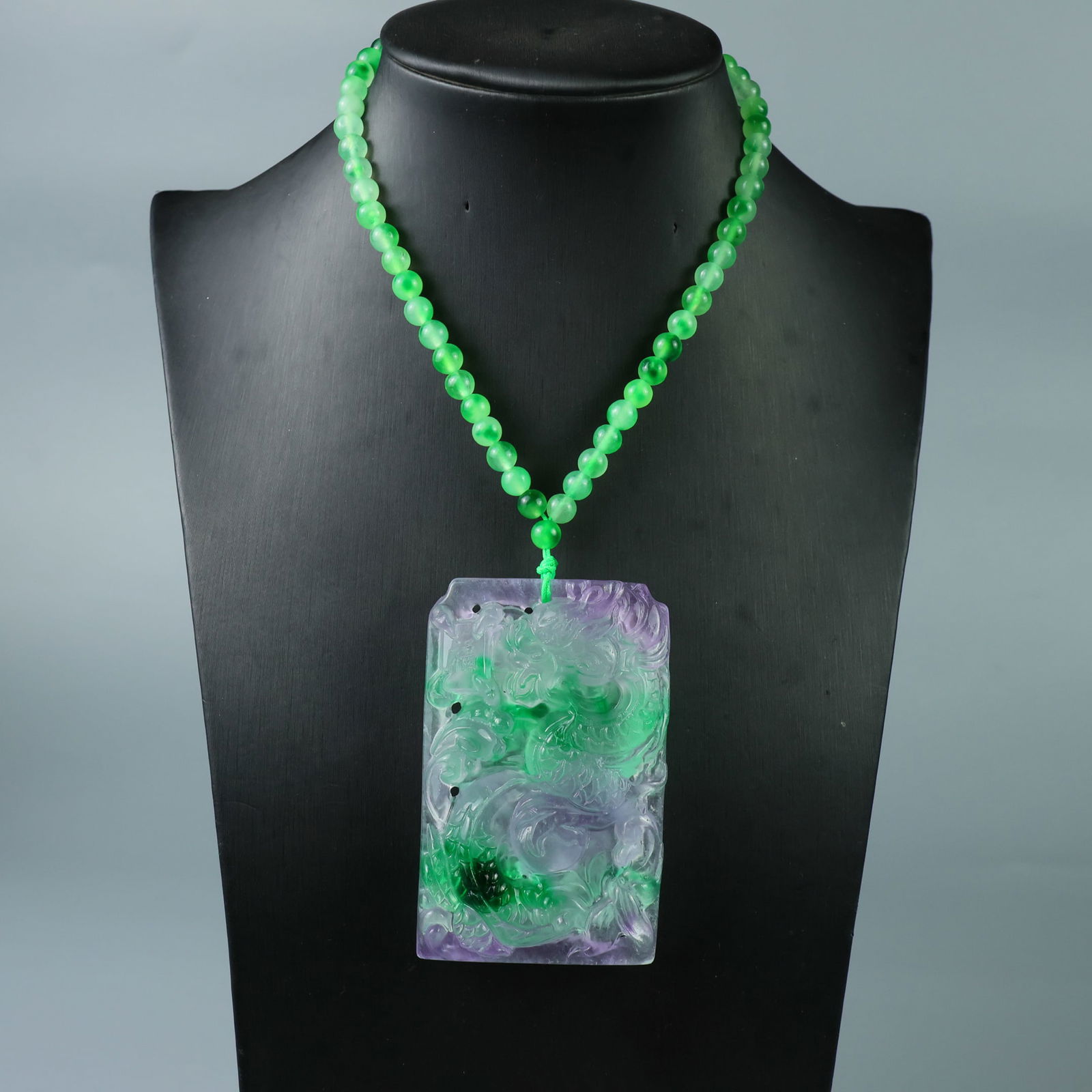 Perfectly crafted high-quality ice crystal dragon plaque.: This exquisitely carved Dragon Pendant is made of high-grade icy jadeite. The base is pure, rich, clean, and translucent with a strong fluorescent effect and excellent rigidity. It is a true icy, tran