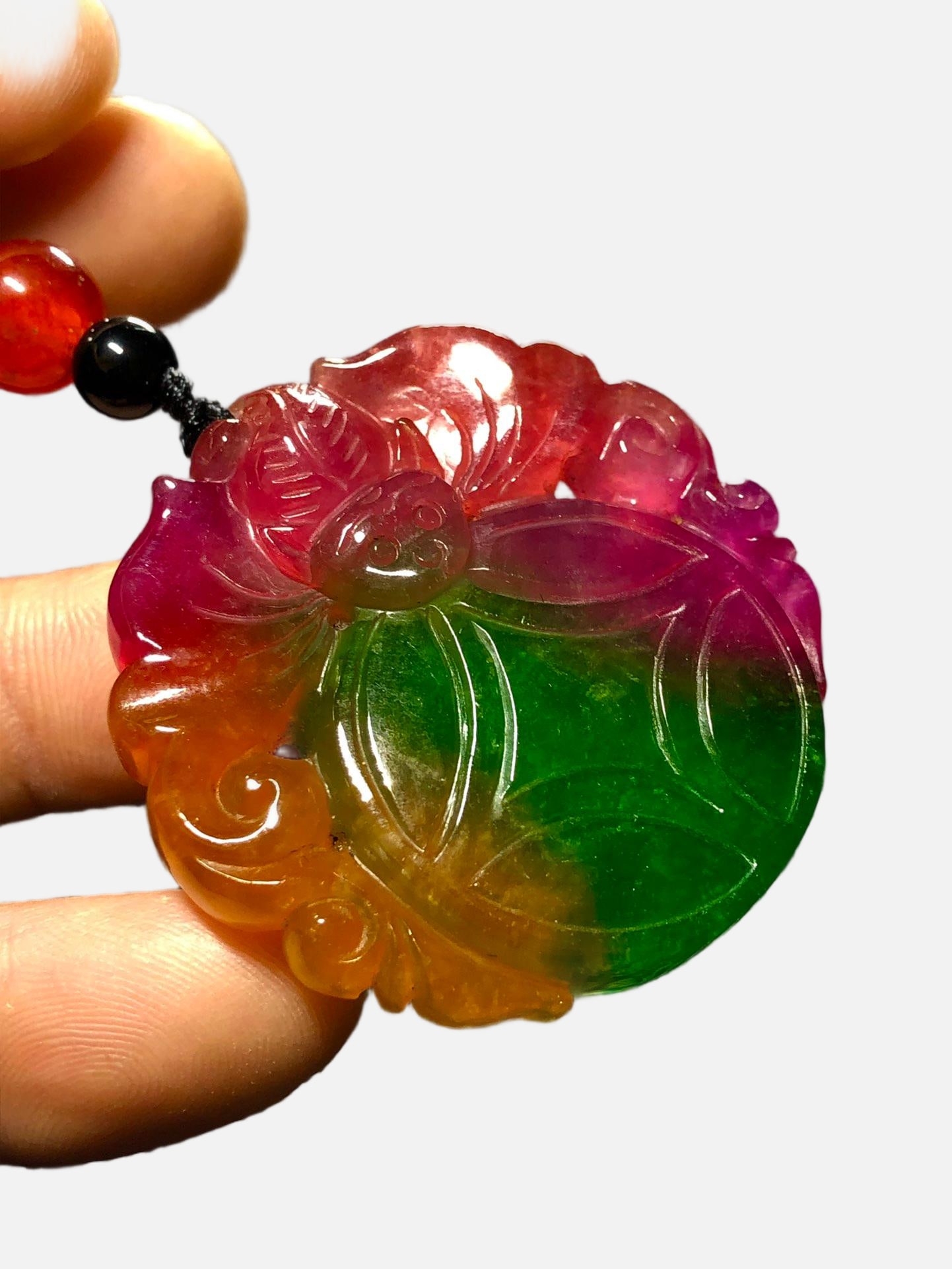 High-quality icy jadeite multi-colored three-dimensional relief pendant with auspicious and: This high-quality, icy jadeite pendant features a colorful, three-dimensional relief carving of auspicious symbols of good fortune and longevity. Made from superior material, it is icy and translucent