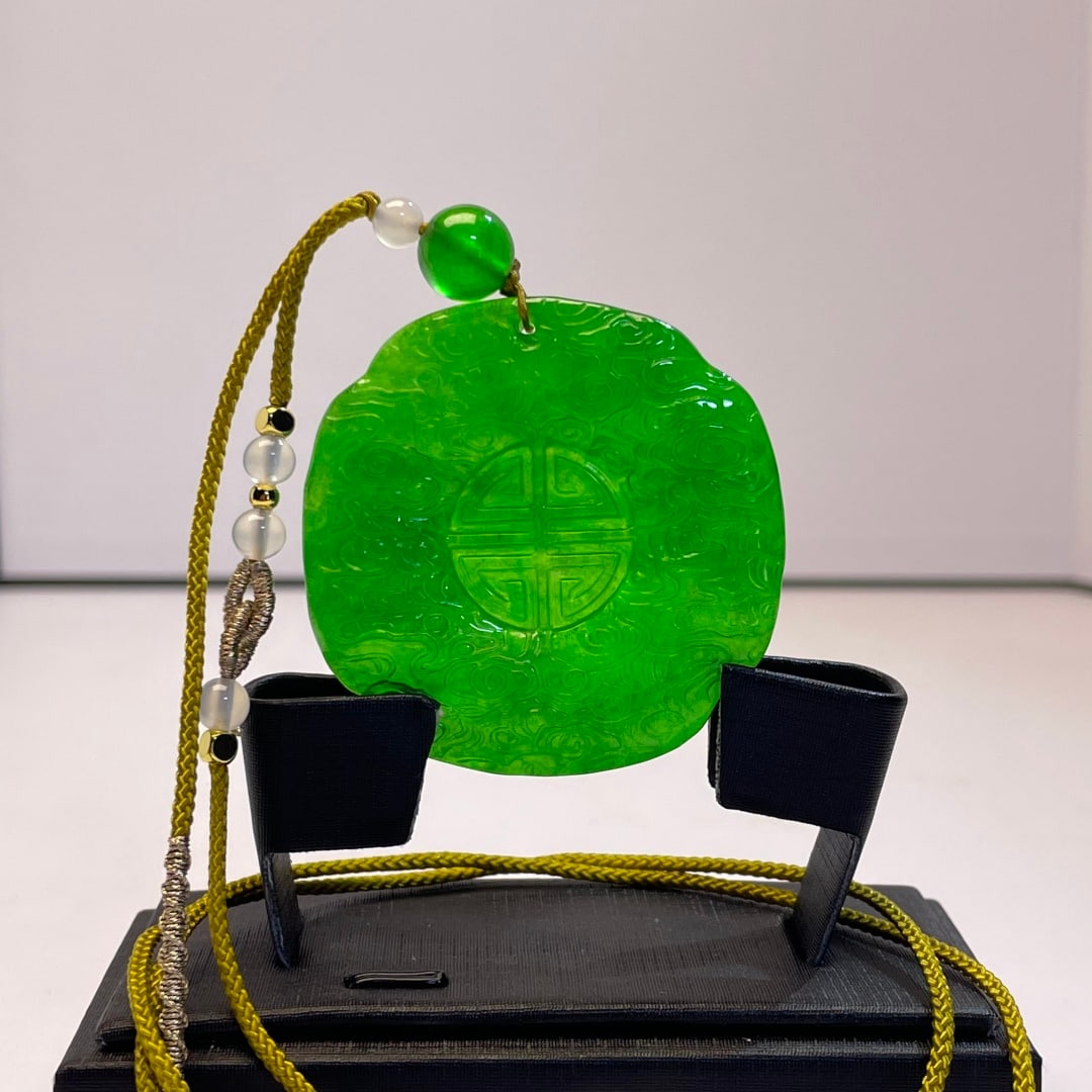 High-grade imperial green jadeite peace pendant: High-grade imperial green jadeite peace pendant, can withstand ultraviolet light. Provenance:Private collection from a professor in Paris-Saclay University. Our cooperative logistics services