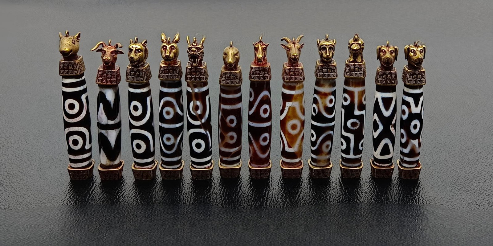 Extra Large Zodiac Dzi Bead: Extra-large Chinese Zodiac Dzi Beads: Approximately 79 x 12 mm, single bead weight approximately 31 g, total weight 348 g Provenance:Private collection, Marseille, France. Our cooperative logistics