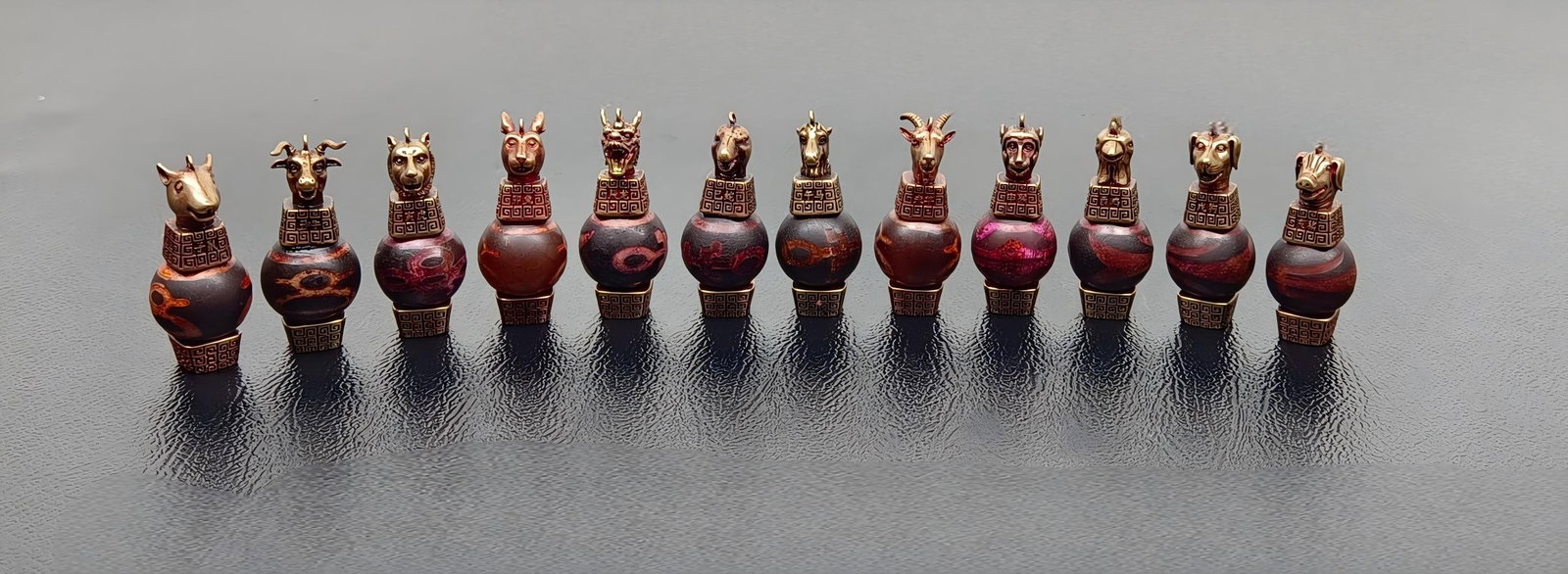 Chinese Zodiac Dzi Beads: The twelve zodiac animal dzi beads are approximately 46 x 20 mm in size, each weighing about 24 grams, with a total weight of 287 grams. Provenance:Private collection, Marseille, France. Our