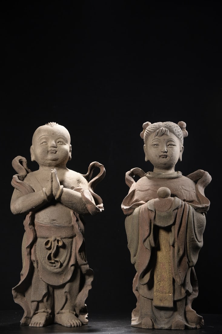 A pair of wooden carvings of a boy and a girl (1 of 9)