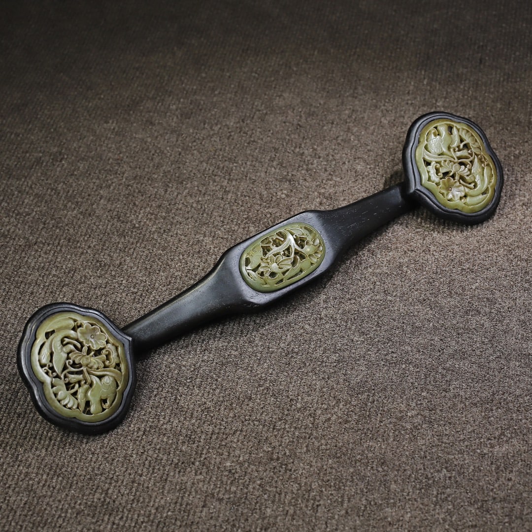 Early collection of ebony wood inlaid with jade Ruyi ornament: An early collection of ebony and jade-inlaid ruyi ornaments, 42 cm long, 9.5 cm wide, and weighing 450 grams. Provenance:From a noted private collection in Bavaria, Germany. Our cooperative logistics