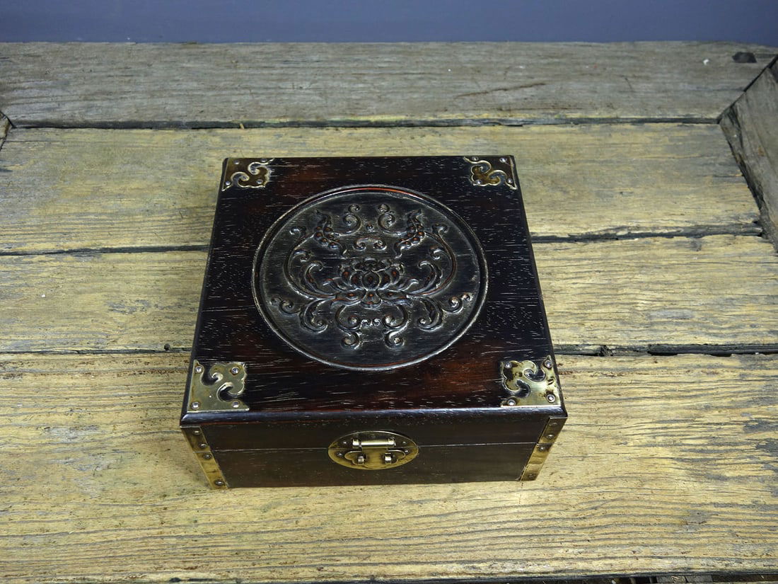 An old collection of rosewood exquisitely carved treasure box with copper-wrapped corners,: An old, finely carved rosewood box with copper-wrapped corners, featuring a continuous series of auspicious symbols. Dimensions: Length 20cm, Width 20cm, Height 10cm. Weight: 910g. Provenance:From a n