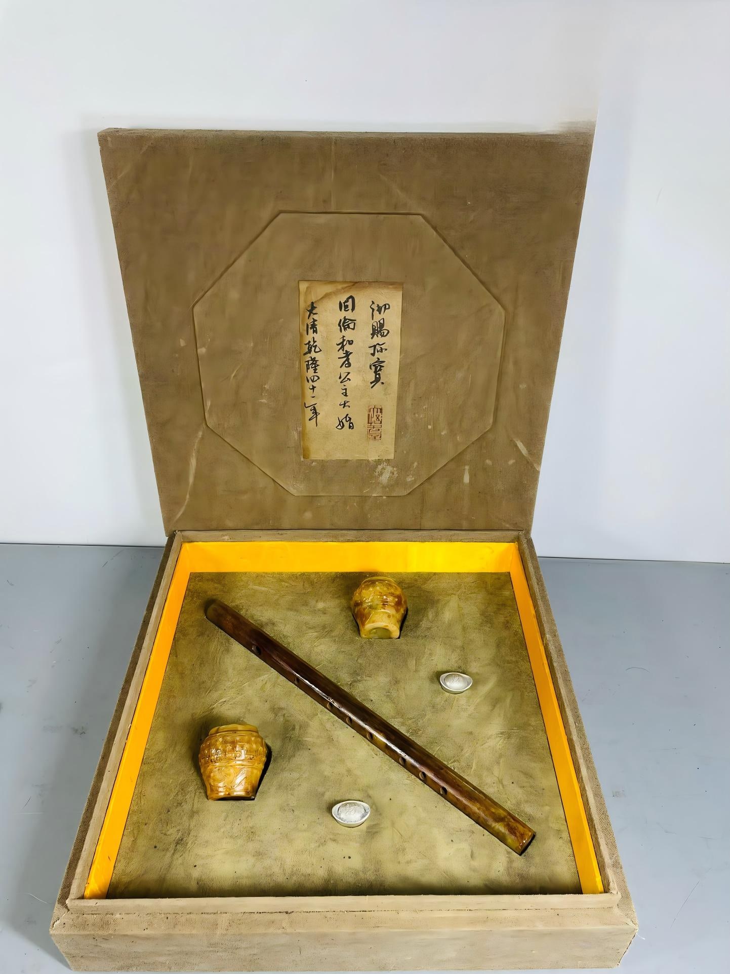 A set of ancient Hetian jade jar, jade flute, and ingot.: A set of ancient Hetian jade jar, jade flute, and ingot. Box dimensions: 39 x 39 x 11 cm; jar dimensions: 6 x 7 cm; flute dimensions: 36.5 x 2 cm; ingot dimensions: 3 x 1.5 cm; total weight: 10 g;