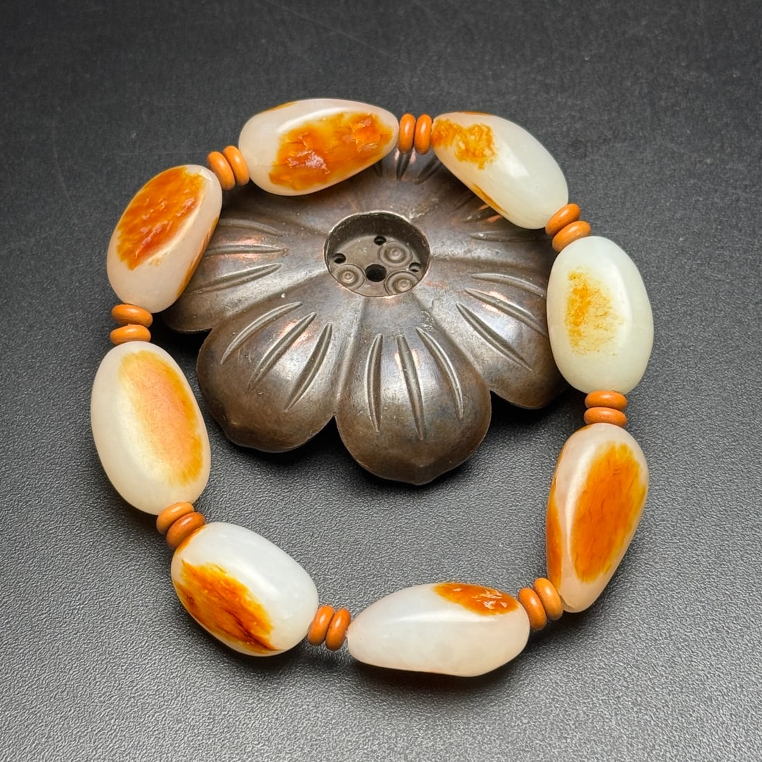 Hetian jade raw stone bracelet: Exquisite Hetian jade raw stone bracelet. The jade is warm and lustrous, with a rich patina and beautiful color. Each bead measures 25 x 15 x 9 mm and weighs 50 g. Provenance:Private collection,