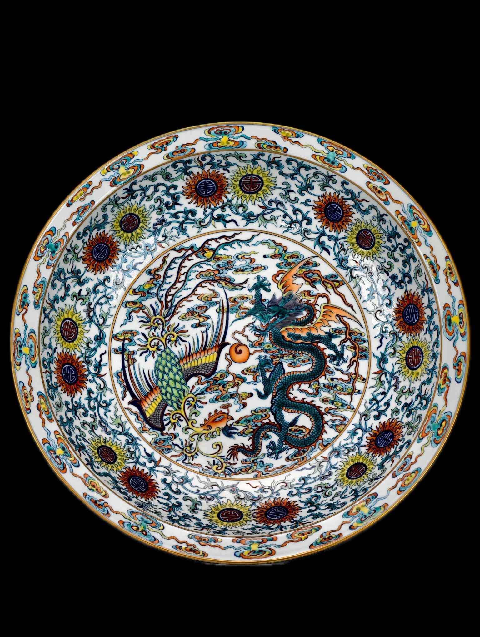 A doucai (enamel-painted) plate with lotus scrolls, open windows, and dragon and phoenix design, (1 of 9)