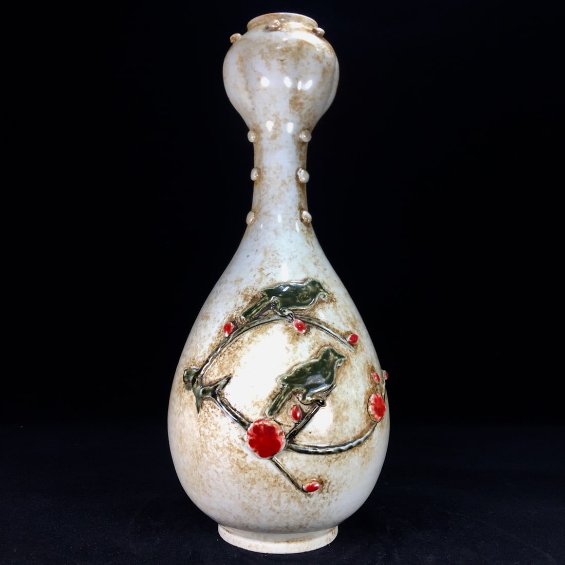 A Song Dynasty Ding ware garlic-shaped vase with a rich, aged patina. (1 of 9)