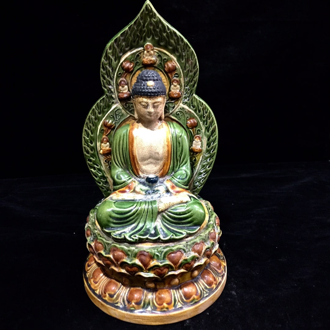 A Tang Dynasty tri-colored glazed pottery Guanyin Buddha with a beautiful patina. (1 of 7)