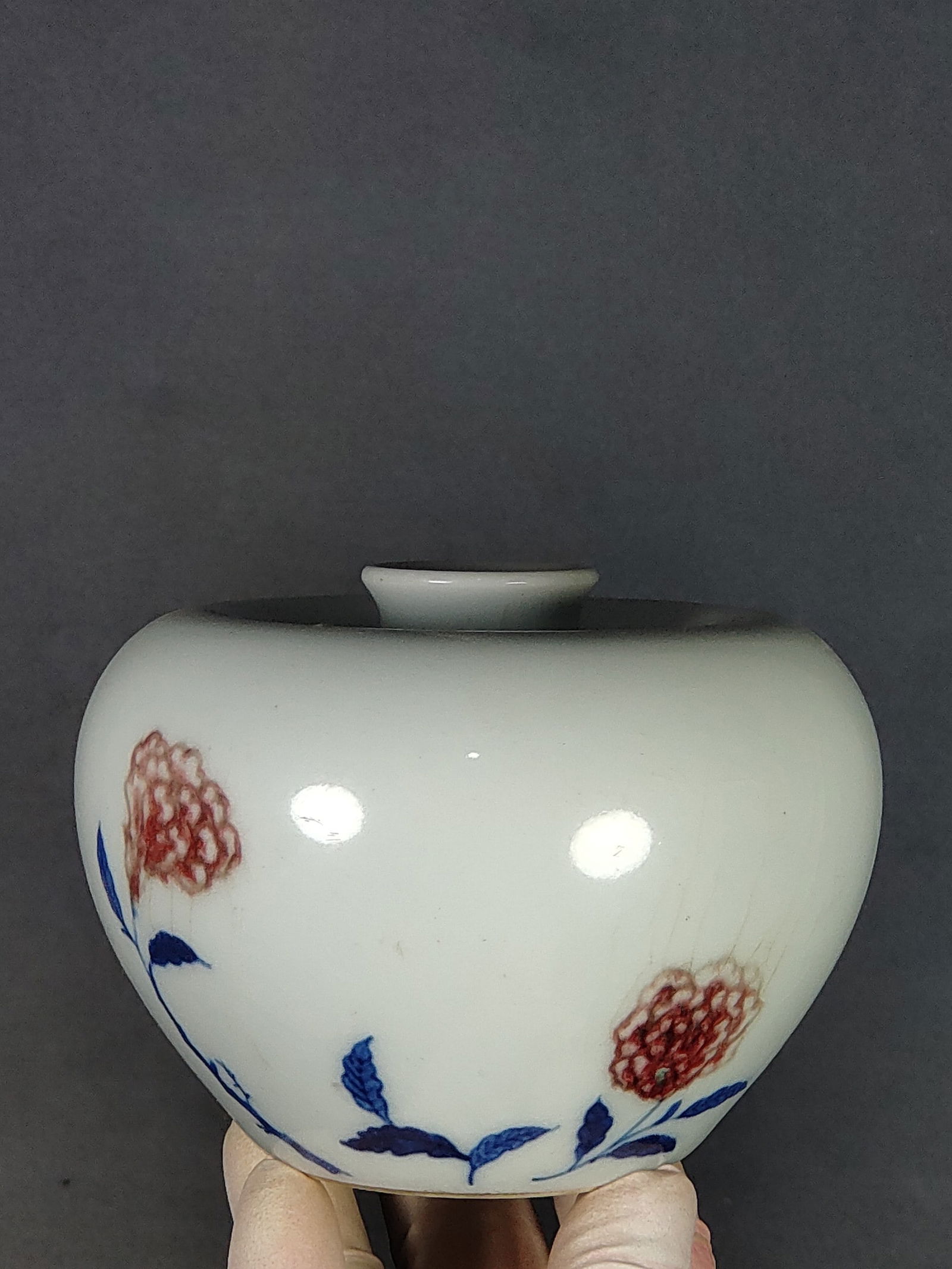 A blue-and-white underglaze red re-fired apple-shaped vase made during the Kangxi period of the Qing (1 of 7)