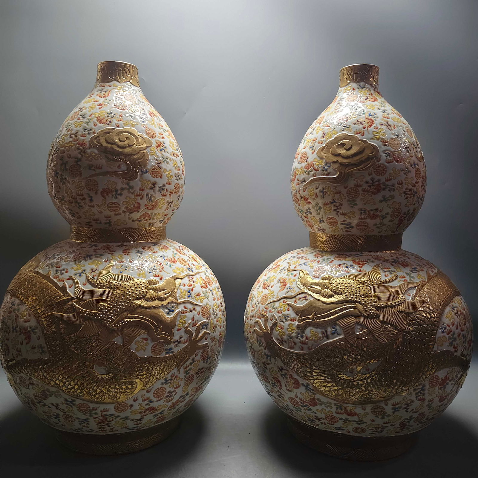 A white-glazed gourd-shaped vase with dragon and phoenix motifs and gilt decoration, made during the (1 of 7)