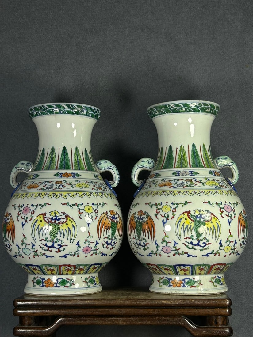 A pair of doucai (enamel overglaze) phoenix-patterned double-eared vases made during the Yongzheng: A pair of doucai (enamel overglaze) phoenix-patterned double-eared vases made during the Yongzheng reign of the Qing Dynasty. Provenance:Private collection from a professor in ESC Rennes School of