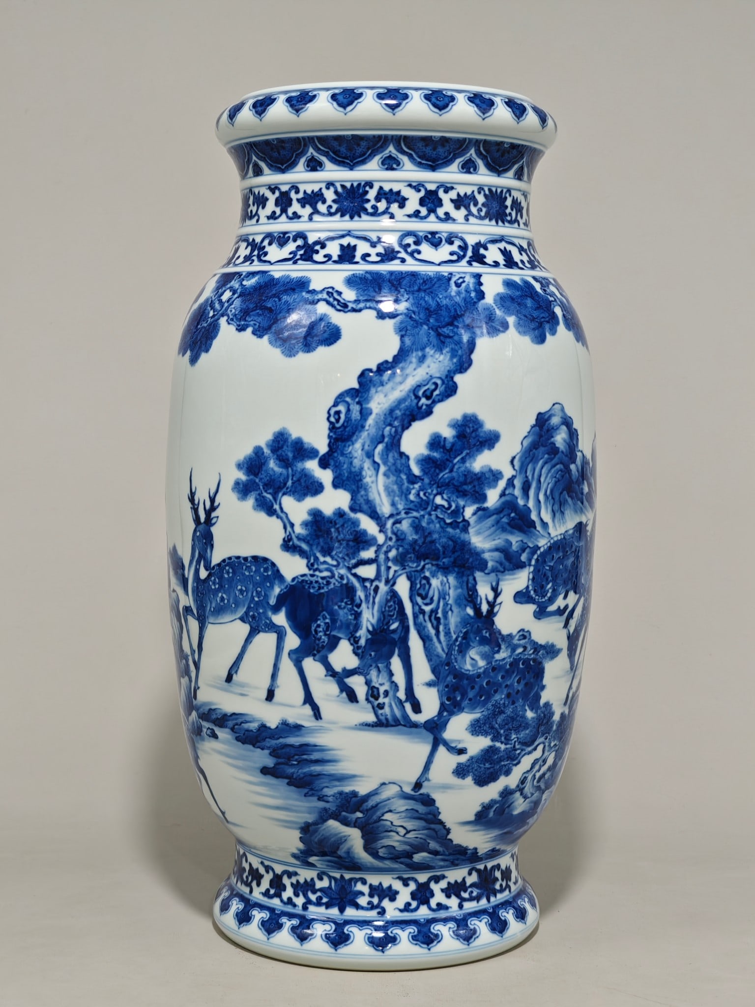 A blue and white porcelain vase with a design of pine trees and deer, bearing the mark of the: A blue and white porcelain vase with a design of pine trees and deer, bearing the mark of the Yongzheng Emperor of the Qing Dynasty. The vase measures 42 cm in height and 22 cm in diameter.