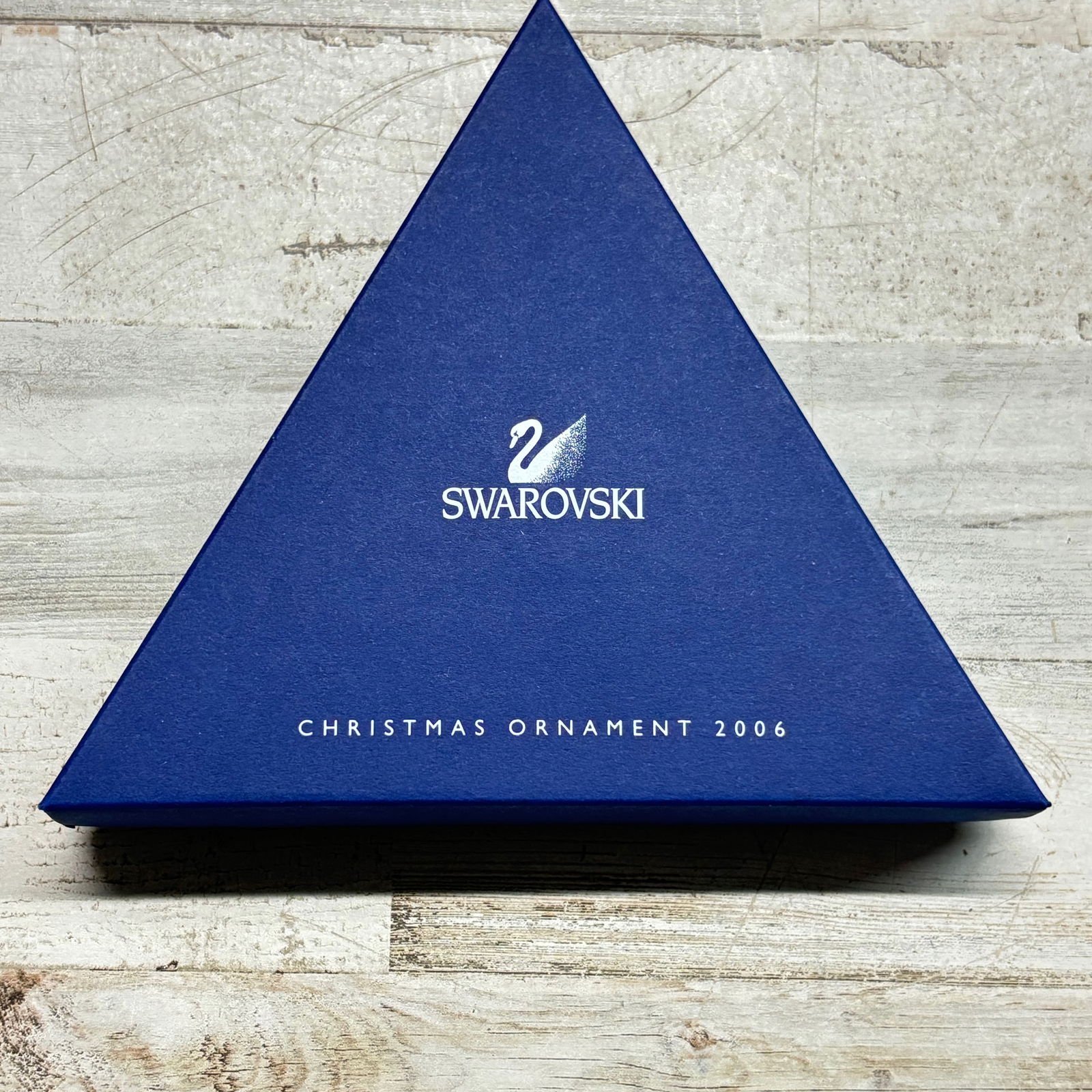 Swarovski Annual Edition Christmas Ornament 2006 Crystal Snowflake: Swarovski Annual Edition Christmas Ornament dated 2006. Faceted crystal snowflake ornament with blue ribbon hanger. Includes original triangular Swarovski presentation box, inner packaging, foam inser