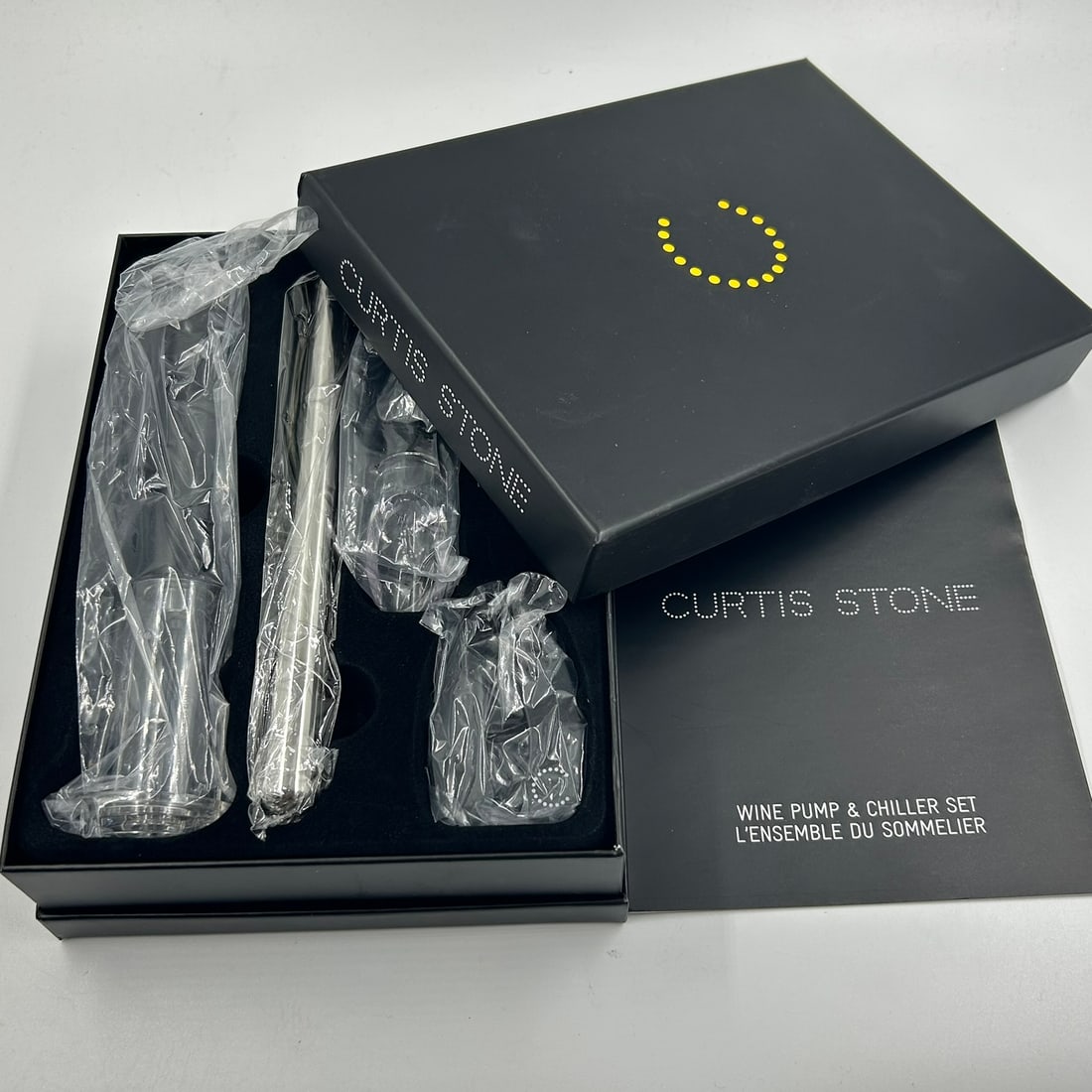 Curtis Stone Wine Pump & Stainless Steel Chiller Sommelier Set: Curtis Stone branded wine accessory set presented in the original fitted box. This sommelier set includes a stainless steel wine chiller with integrated pourer, wine pump, aerator, foil cutter, and re