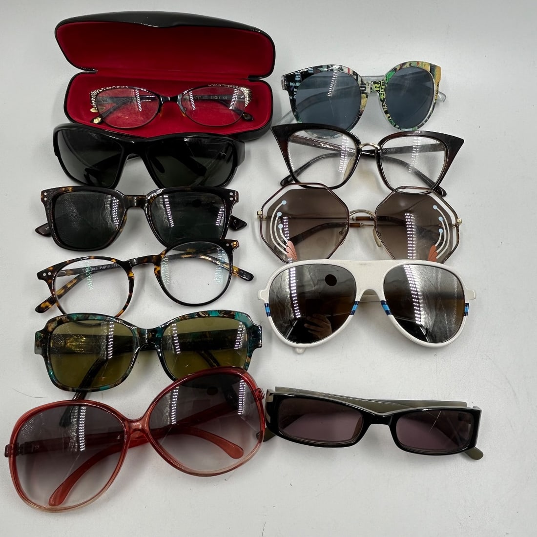 Lot of 9 Pairs Designer Eyeglasses & Sunglasses - Various Brands: This lot features a diverse collection of nine pairs of eyeglasses and sunglasses, showcasing a range of styles and brands. Included are fashion-forward sunglasses with unique patterns and bold frames