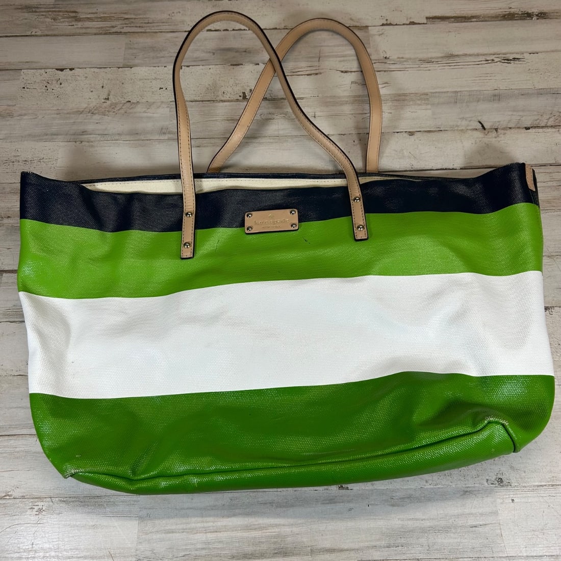 Kate Spade New York Large Striped Tote Bag PVC Coated Canvas Leather Trim: Add a pop of color and designer flair to your everyday carry with this spacious Kate Spade New York tote bag. Featuring bold green, white, and navy horizontal stripes on a durable PVC-coated canvas, t