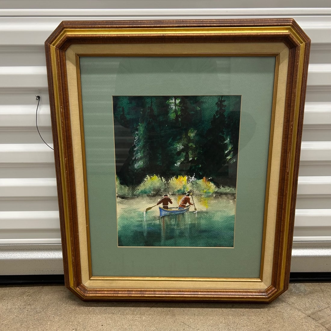 Watercolor Painting Two Canoers Forest Lake Scenic Landscape Signed Art: Charming watercolor painting depicting two individuals canoeing on a serene lake, surrounded by a dense forest. The artist has skillfully captured the reflections on the water and the vibrant colors o