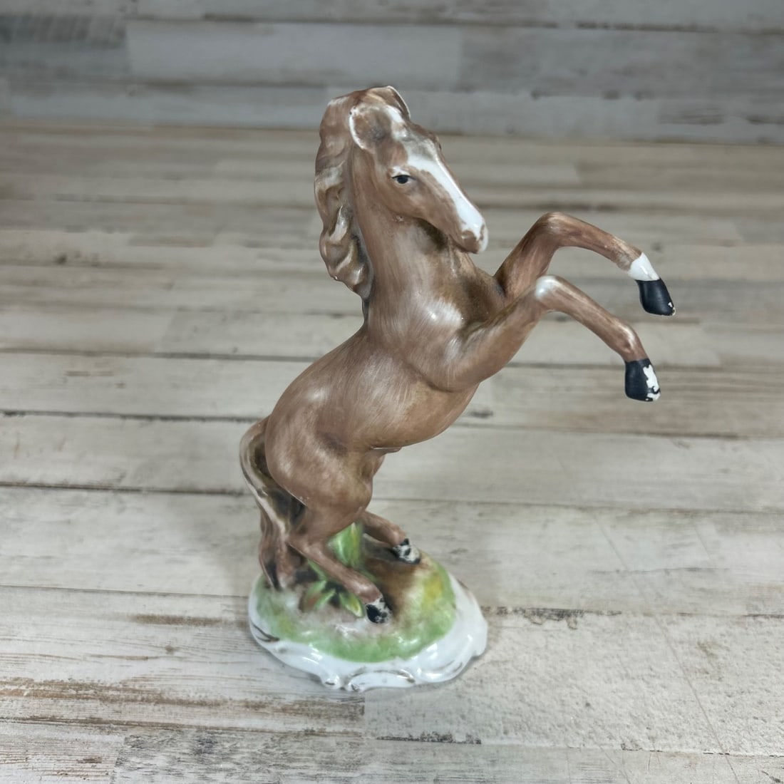 Vintage Italian Porcelain Rearing Horse Figurine "900/64" Mark: This charming vintage porcelain figurine depicts a rearing horse in dynamic motion. Crafted in Italy, it features a rich brown glaze with detailed mane and tail, and a white blaze on its face. The hor
