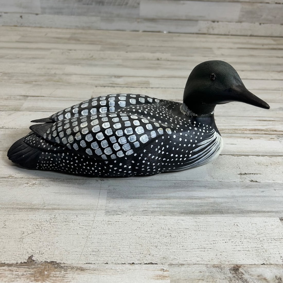 Carved Wooden Loon Decoy "Renee Wickman 5/84" Folk Art Bird Sculpture: This is a charming carved wooden decoy in the form of a loon, signed "Renee Wickman 5/84". The decoy is intricately detailed with hand-painted black and white plumage, capturing the distinctive markin
