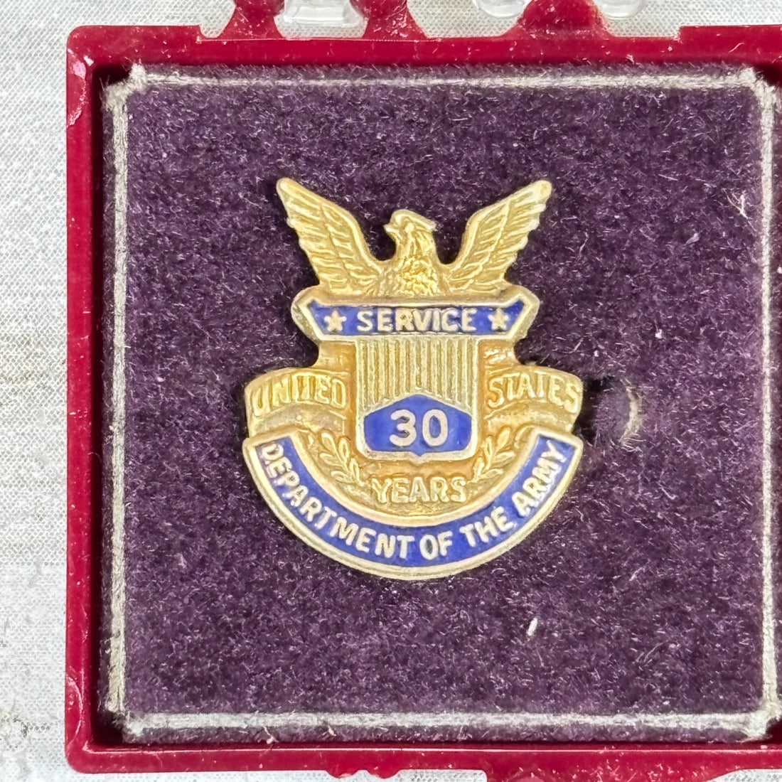 US Army 30 Years Service Lapel Pin Badge "Department of the Army" Enamel Gilt Metal: Here is a US Army lapel pin commemorating 30 years of service. This pin features the Department of the Army insignia with an eagle at the top, "Service" text, and "United States" flanking a central sh
