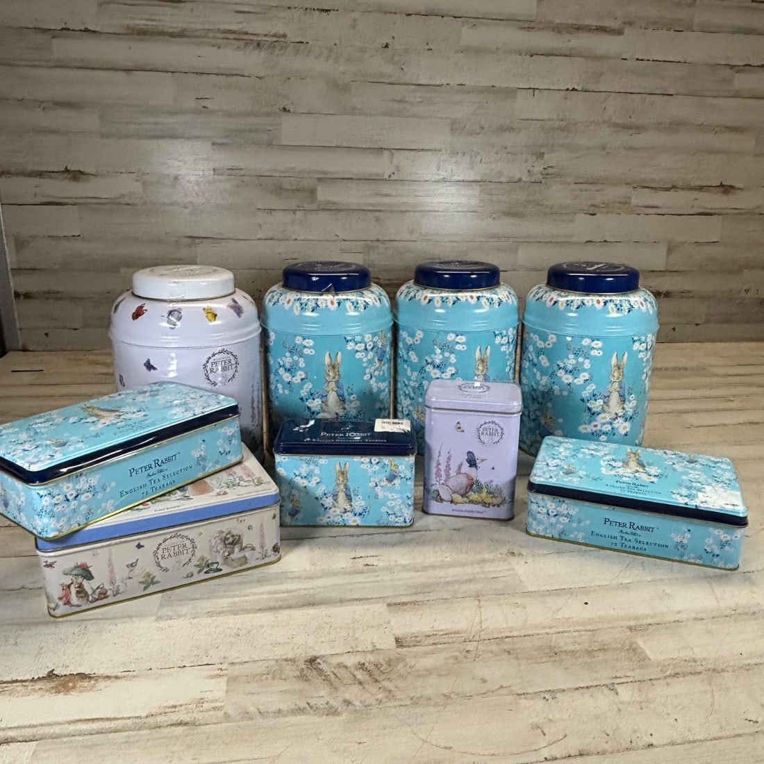 New English Teas Peter Rabbit Beatrix Potter Collection Biscuit Tins & Tea Cans: A charming collection of New English Teas featuring Beatrix Potter's beloved Peter Rabbit characters. This lot includes several decorative tin cans and biscuit tins, ideal for collectors or as delight