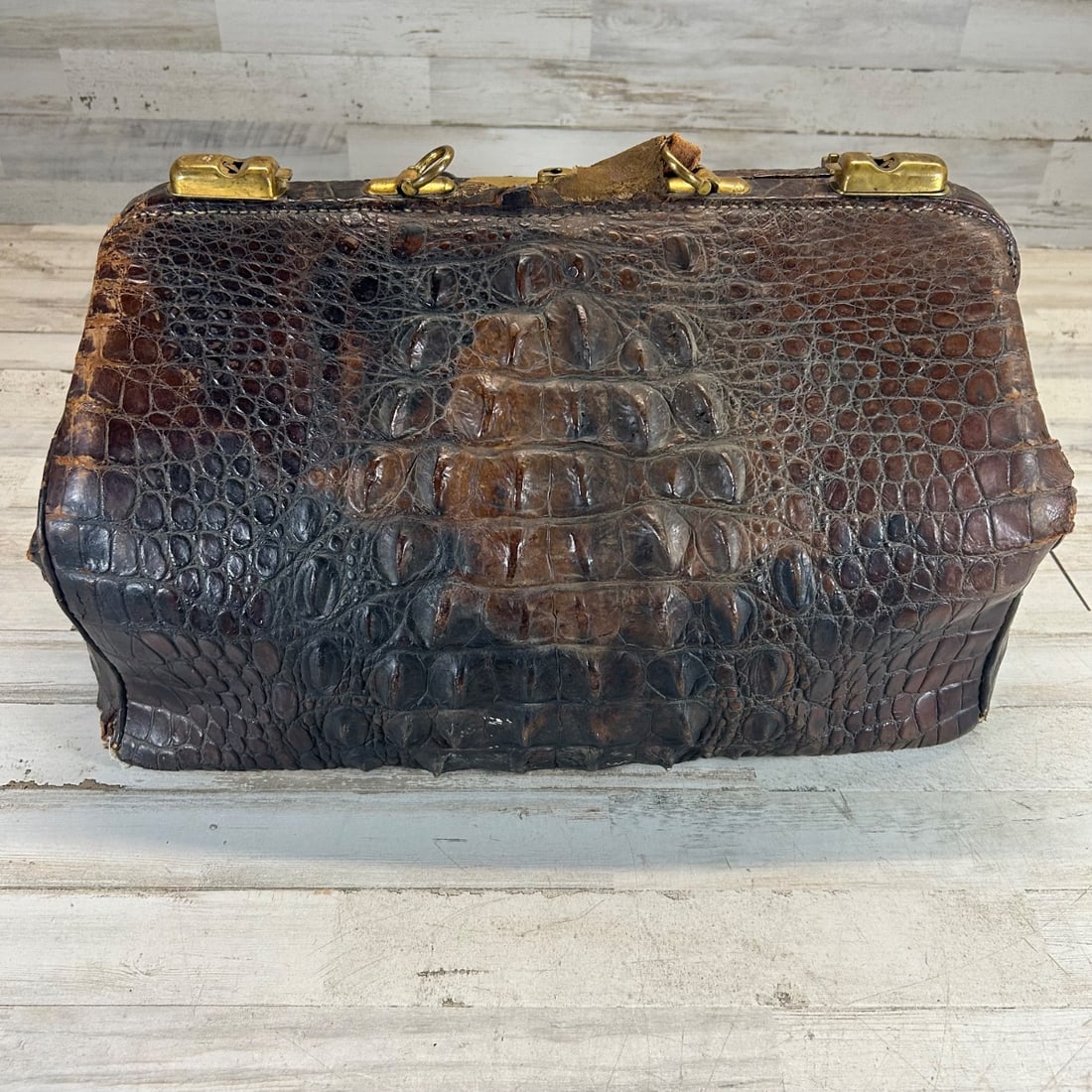 Antique Crocodile Doctor's Bag Satchel Vanity Case Brass Hardware Vanity Clutch: This is a vintage doctor's bag or vanity case crafted from genuine crocodile skin. It features sturdy brass hardware, including latches, a central lock, and a pull ring for the handle. The bag's exter