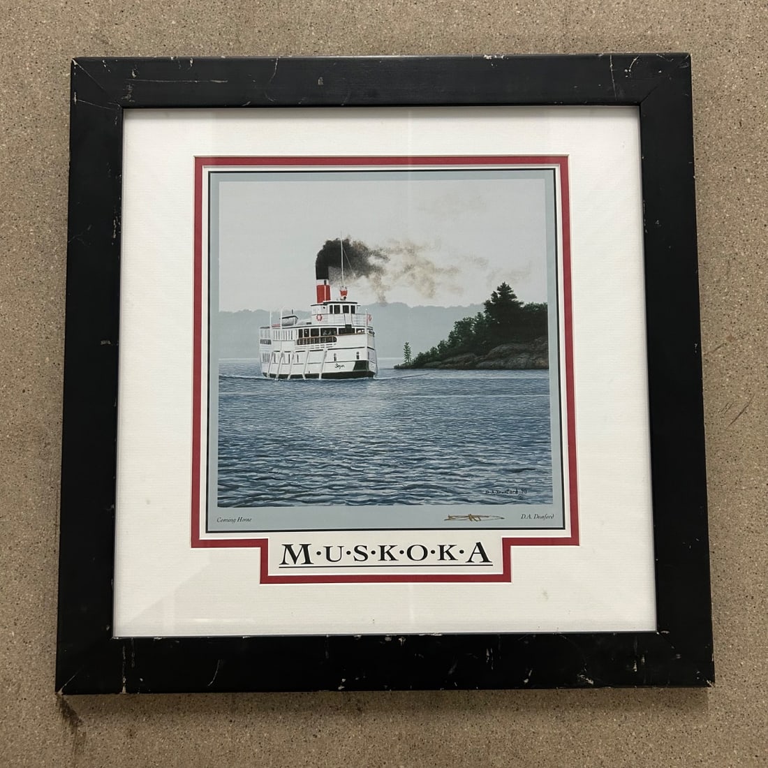 D.A. Dunford "Coming Home" "Muskoka" Steamship Print 1998 Framed Art: This is a charming print titled "Coming Home" by artist D.A. Dunford, dated 1998. The artwork depicts a classic steamship navigating calm waters with wooded islands in the background, evoking a sense
