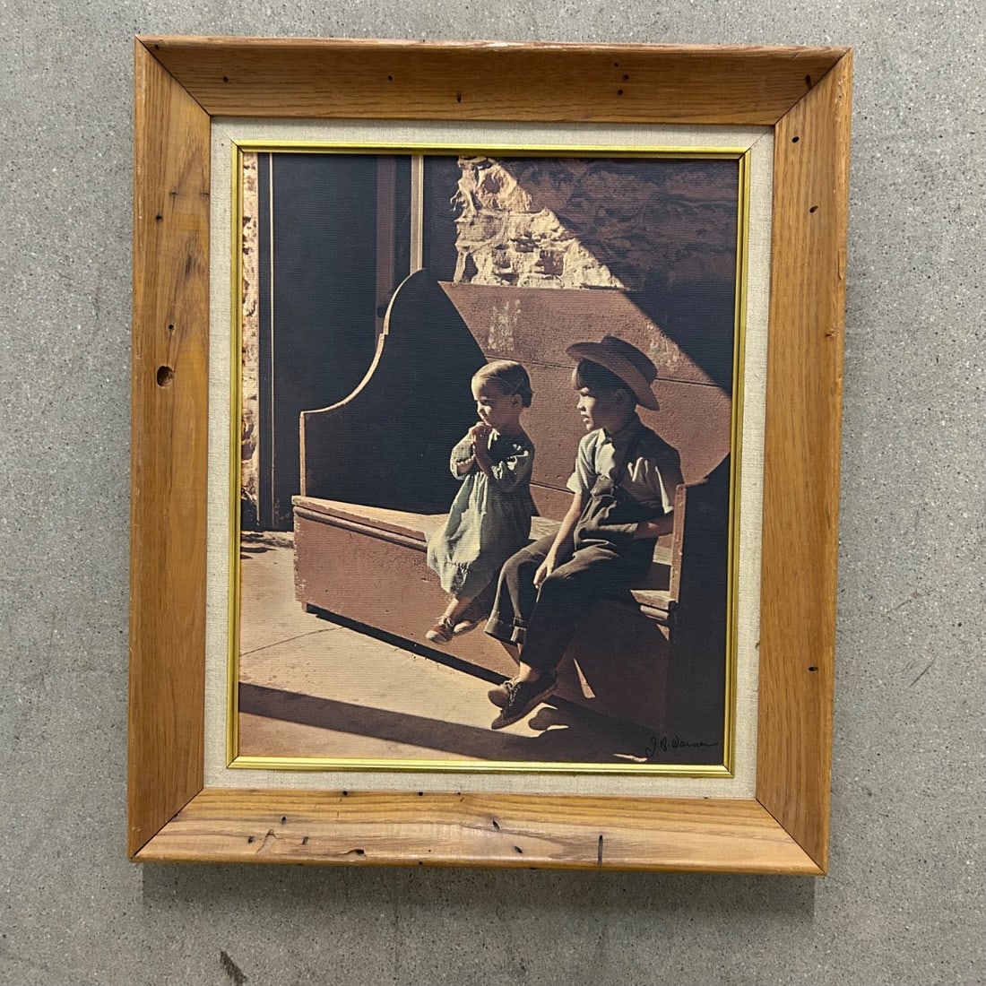 J.B. Warner "The Gentle People" Print Vintage Amish Children Cowboy Hat Barn: Vintage print titled "The Gentle People" by J.B. Warner, depicting two young Amish children sitting on a wooden bench, one with a cowboy hat. The print captures a moment of quiet contemplation and inn