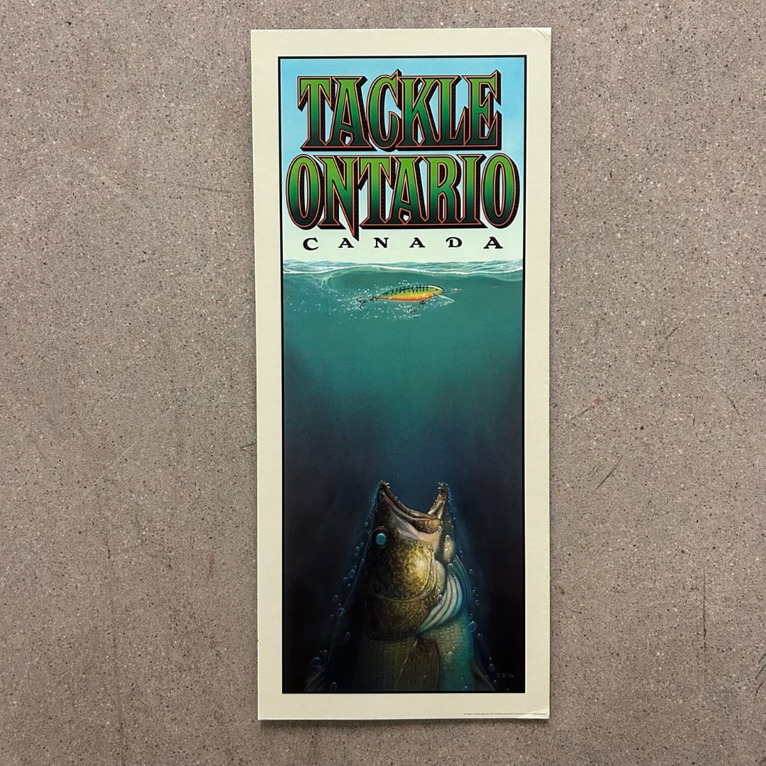 Tackle Ontario Canada Vintage Fishing Print Walleye Art Poster: This vintage "Tackle Ontario Canada" print showcases a dramatic underwater scene of a walleye lunging for a fishing lure. The artwork captures the thrill of the catch with vibrant colors and meticulou