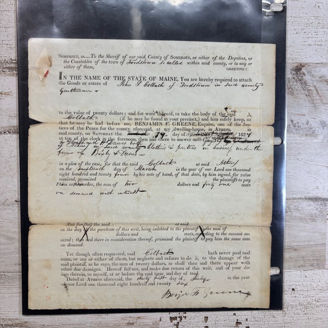 1824 Maine Sheriff's Writ of Attachment Debt Collection Document: This is a legal document, specifically a writ of attachment from the State of Maine, dated 1824. It details a debt owed by the estate of John G. Bollath, gentleman, to Benjamin F. Greene. The writ ins