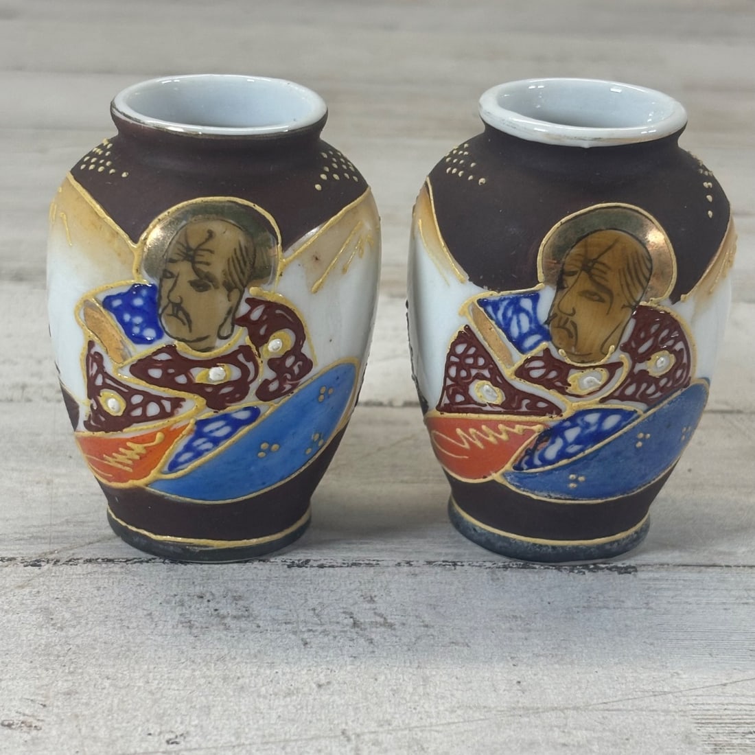 Pair Occupied Japan Porcelain Vases Miniature Figural Imperial Portrait: This pair of charming miniature porcelain vases dates from the Occupied Japan era, featuring intricate hand-painted scenes of what appear to be imperial portraits. Each vase showcases a profile of a d
