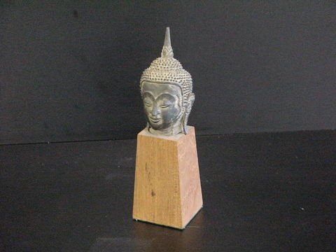 Bronze Cambodian head on wooden base: Bronze Cambodian head on wooden base, measures 8" high