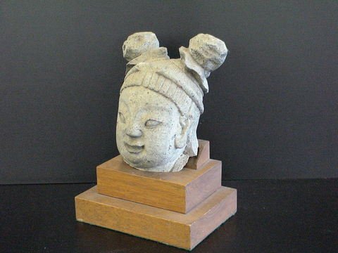Heavy limestone carved Cambodian head: Heavy limestone carved Cambodian head on a wooden two tiered base. Base measures 7"x5" and sculpture is 11" high