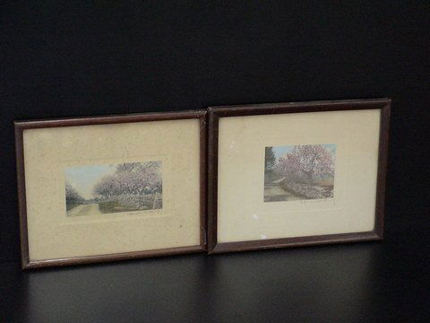 Set of two lovely matted and framed hand-colored: Set of two lovely matted and framed hand-colored signed photographs by Wallace Nutting of a country road with pink trees alongside, 8x10.