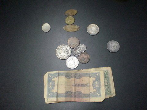Lot of miscellaneous coins: three Japanese Govern: Lot of miscellaneous coins: three Japanese Government One Peso Notes, one oblong stretched Trans Mississippi Expo Liberty coin dated 1894, 2 unknown half dollar size very worn coins, 1899 One Dollar U