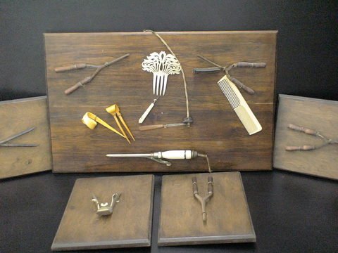 5 Display Boards /Vintage Beauty Tools: Set of 5 wooden display boards with beauty attachments: vintage crimpers, straighteners, curling irons, Bakelite hair accessories, and a celluloid decorative comb, hair comb, nail file, etc.