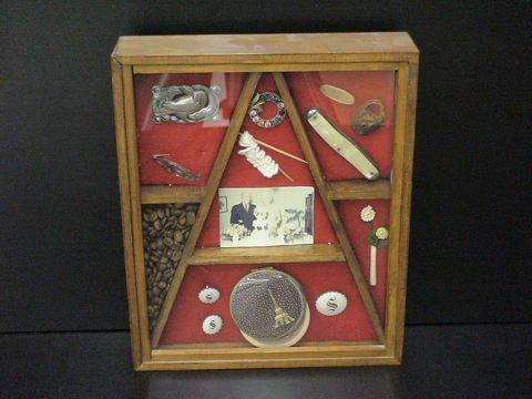 Shadow Box - Sterling, Travel, etc.: Shadow box filled with personal mementos: anniversary picture, paper flowers, sterling silver brooches, pins, pocket knife, travel mementos, and so on, 10x12.