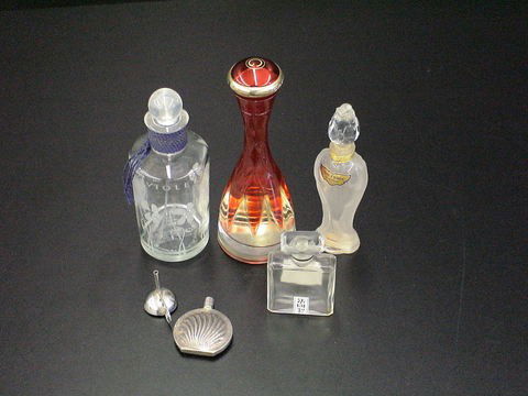 Lot of five perfume decanters: one slender red de: Lot of five perfume decanters: one slender red decanter Cabaret Parfums Gres, made in France, one small Chanel No. 5, Paris decanter, one Chant d'Aromes Guerlains Paris decanter, one etched violetta d