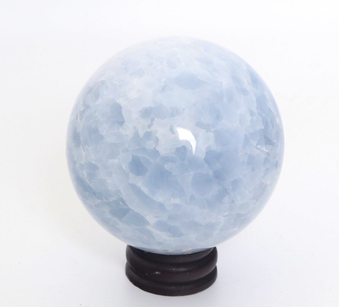 Light Blue Aquamarine Sphere on Stand: Beautiful all natural section of aquamarine mineral polished into a lovely sphere with included wood stand. Natural light blue to snow cap white coloring throughout. Beautiful all natural section of
